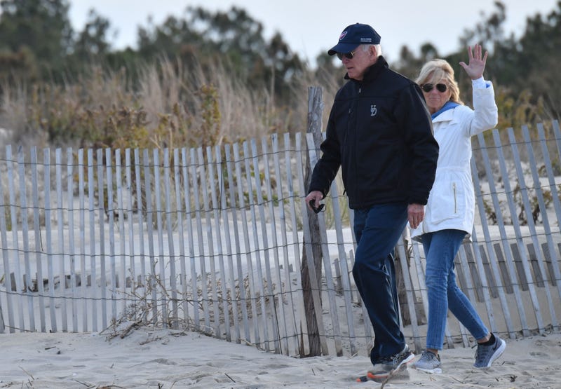 US President Joe Biden and First Lady Jill Biden walk to the beach at Cape Henlopen State Park in Lewes, Delaware on November 7, 2021.