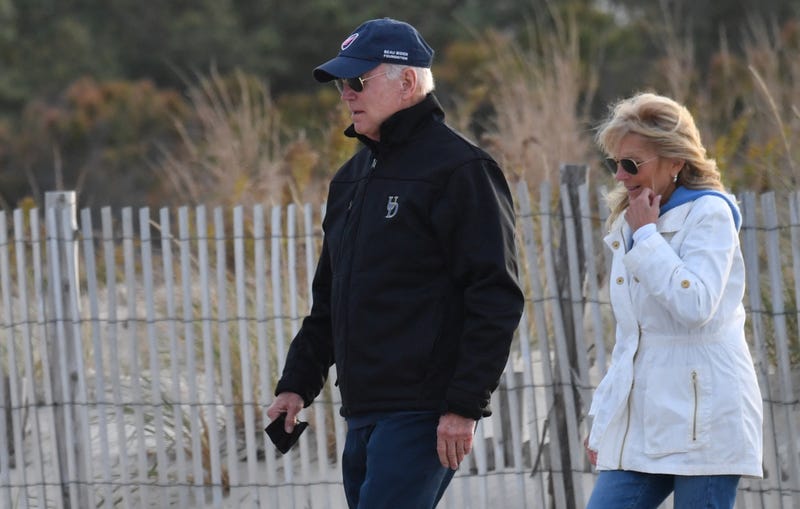 US President Joe Biden and First Lady Jill Biden walk on the beach at Cape Henlopen State Park in Lewes, Delaware on November 7, 2021.