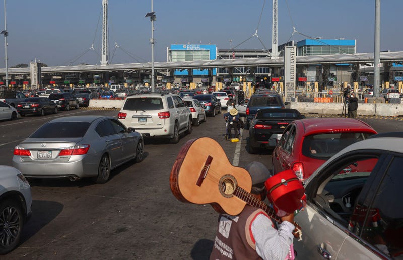 Motorists wait in line to cross the border at the San Ysidro Port of Entry on November 8, 2021 in Tijuana, Mexico. Monday was the official opening of the border to non-essential visitors as COVID restrictions eased. (Photo by Sandy Huffaker/Getty Images)