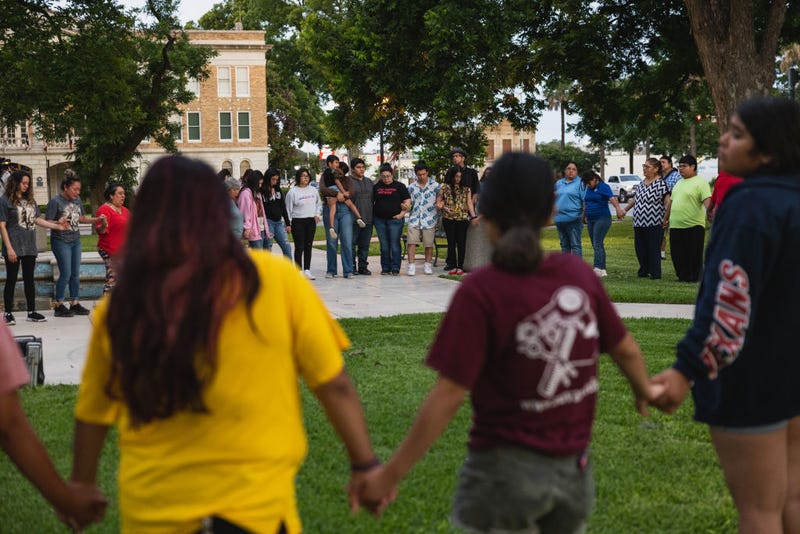 Members of the community gather at the City of Uvalde Town Square for a prayer vigil in the wake of a mass shooting at Robb Elementary School on May 24, 2022 in Uvalde, Texas. According to reports, 19 students and 2 adults were killed before the gunman was fatally shot by law enforcement. (Photo by Jordan Vonderhaar/Getty Images)