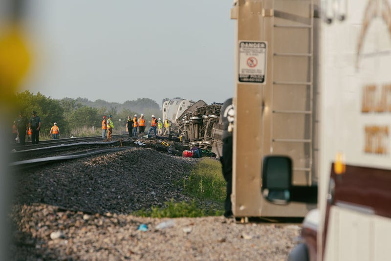 Police and railroad workers work the scene where an Amtrak train derailed on June 27, 2022, in Mendon, Missouri. The train, traveling from Los Angeles to Chicago, reportedly struck a dump truck at a crossing killing at least three people and injuring dozens.