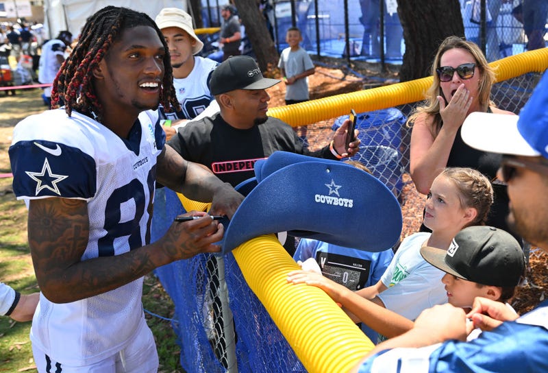Wide receiver CeeDee Lamb #88 of the Dallas Cowboys signs autographs during training camp drills at River Ridge Fields on August 1, 2022 in Oxnard, California.