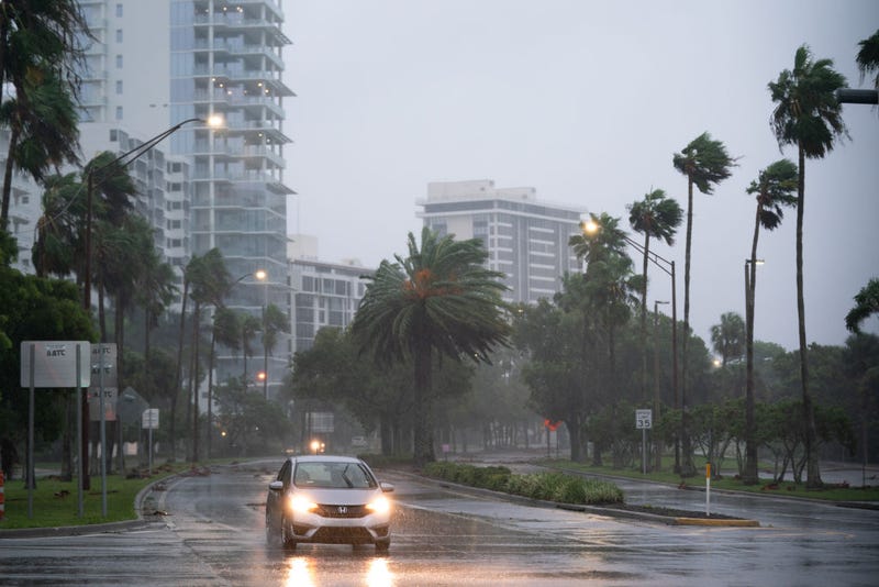 A motorist travels near the Sarasota Bay waterfront as Hurricane Ian approaches on September 28, 2022 in Sarasota, Florida.