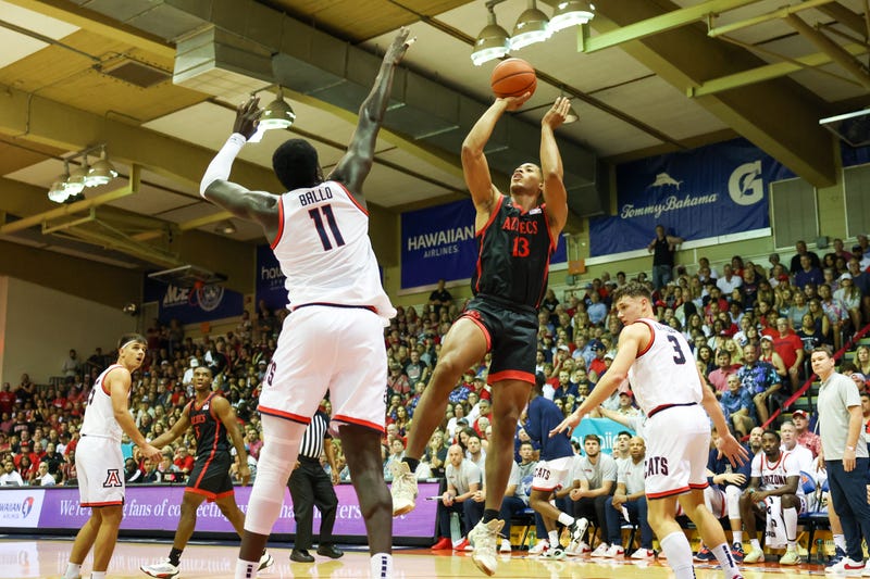 Jaedon LeDee of the San Diego State Aztecs takes a shot over Oumar Ballo of the Arizona Wildcats.