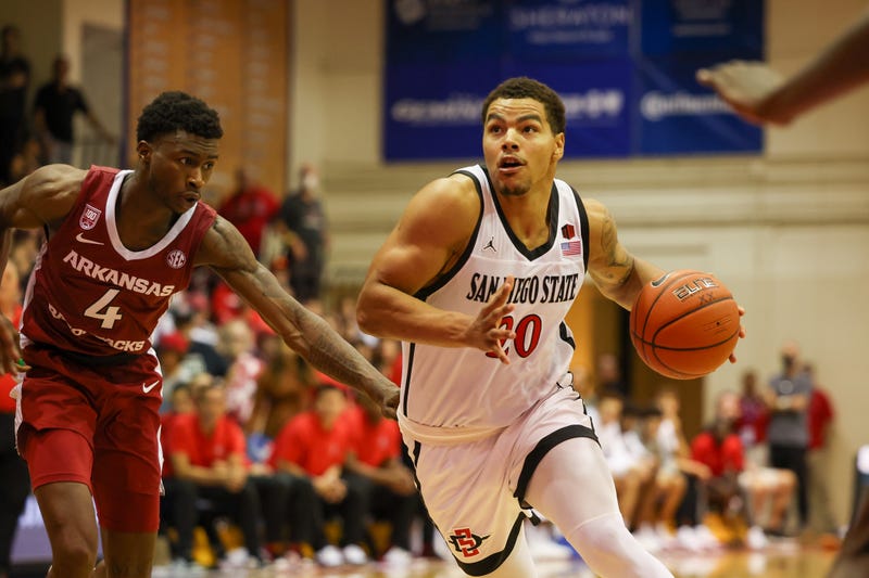 Matt Bradley of the San Diego State Aztecs dribbles past Davonte Davis of the Arkansas Razorbacks in the first half of the game during the Maui Invitational