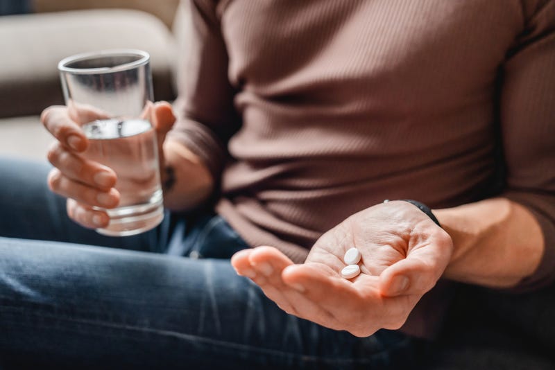 Hand with pills stock photo.