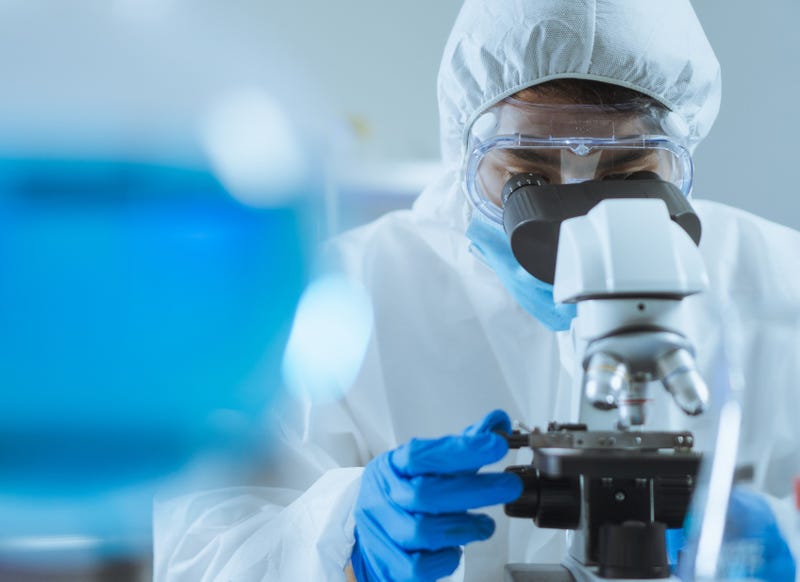 Scientist looking through microscope
