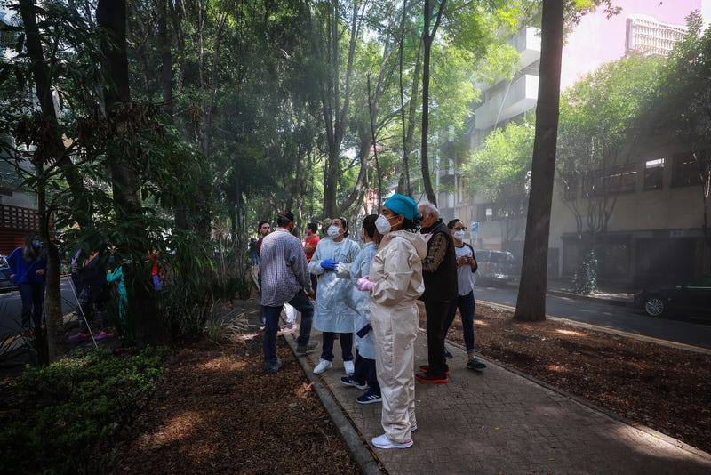 People evacuate buildings at Condesa neighborhood during an earthquake, some of them use face masks as a preventive measure against spreading of COVID-19, on June 23, 2020 in Mexico City, Mexico.