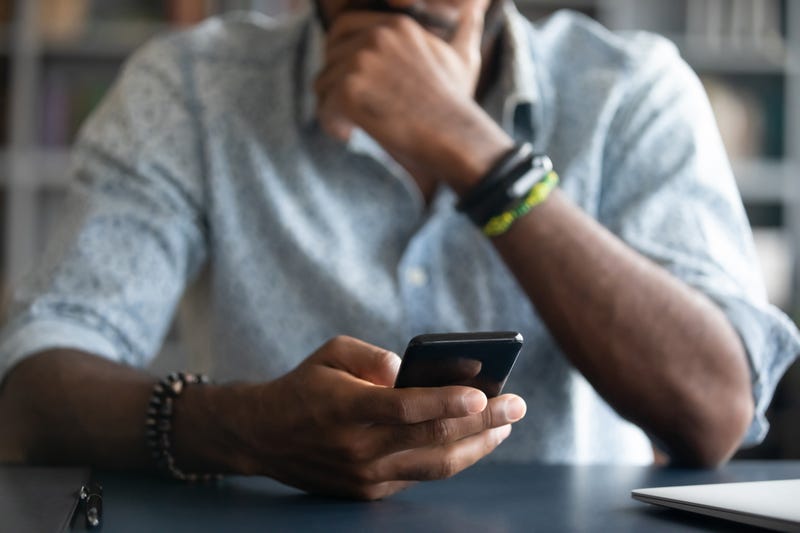 sad man looking at phone