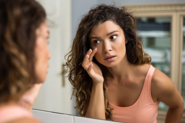 Woman checking bags under her eyes
