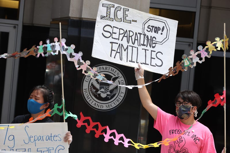 Hoisting paper dolls representing children in detention, protesters rally in front of the U.S. Immigration and Customs Enforcement headquarters, demanding the release of immigrants in ICE detention due to the dangers posed by the coronavirus pandemic July 17, 2020 in Washington, DC.