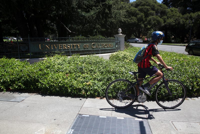 A cyclist rides by a sign in front of the U.C. Berkeley campus on July 22, 2020 in Berkeley, California