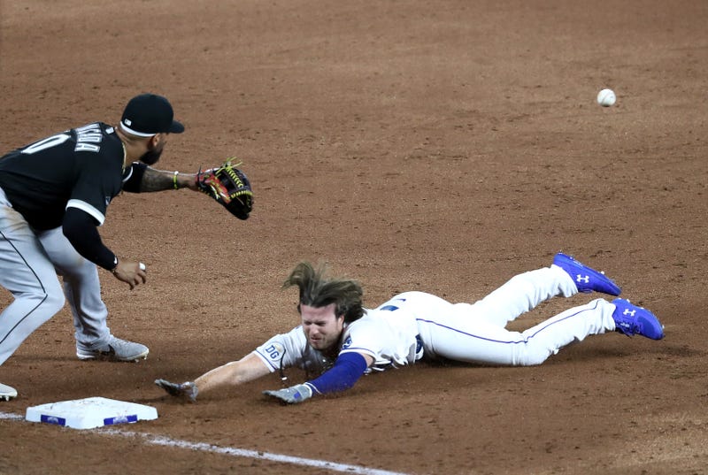KANSAS CITY, MISSOURI - AUGUST 01: Brett Phillips #14 of the Kansas City Royals slides head first into third base during the 9th inning of the game against the Chicago White Sox at Kauffman Stadium on August 01, 2020 in Kansas City, Missouri.