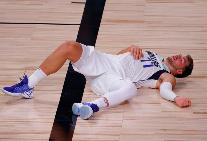 Luka Doncic catches his breath in a game against Milwaukee