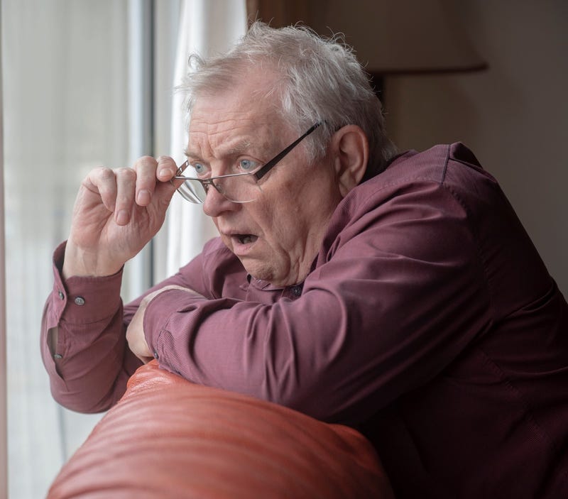 Man staring out window stock photo.