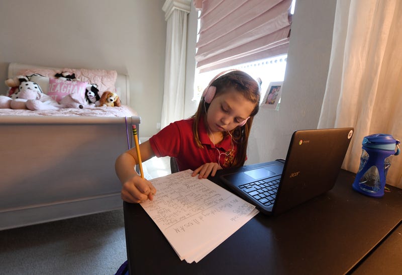 Doral Academy Red Rock Elementary School fourth grader Reaghan Keeler, 9, attends an online reading class from her bedroom on her first day of distance learning amid the spread of the coronavirus (COVID-19) on August 24, 2020