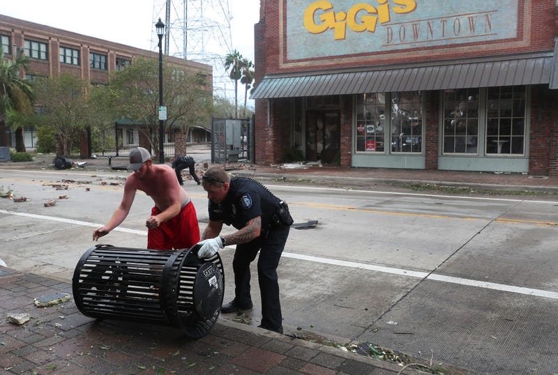 A Lake Charles police officer helps clear the streets in the downtown area after Hurricane Laura passed through on August 27, 2020 in Lake Charles, Louisiana . The hurricane hit with powerful winds causing extensive damage to the city.