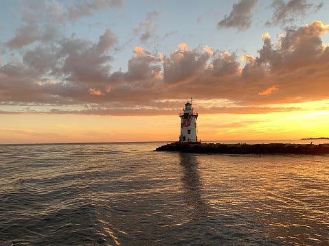 The outer lighthouse at Old Saybrook Connecticut at sunset.