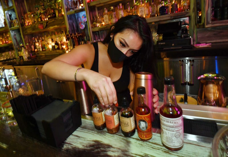 Bartender Brandi Sterner makes drinks after the bartop opened for the first time at Lucky Day bar in the Fremont East Entertainment District on September 21, 2020 in Las Vegas, Nevada.