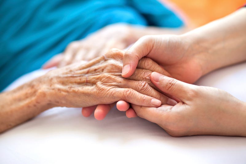 Someone aiding an older person.