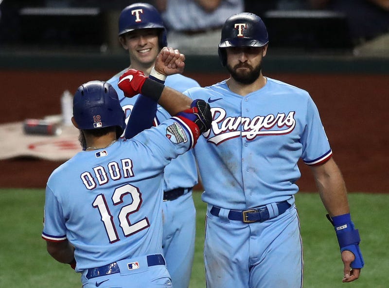 ougned Odor #12 of the Texas Rangers celebrates a three-run home run with Joey Gallo #13 and Nick Solak #15 against the Houston Astros in the fourth inning at Globe Life Field.
