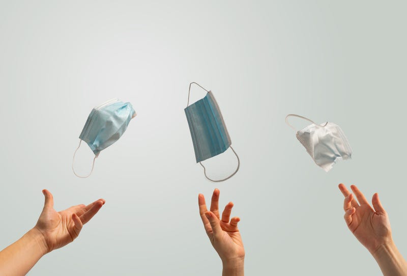 people throwing away protective masks