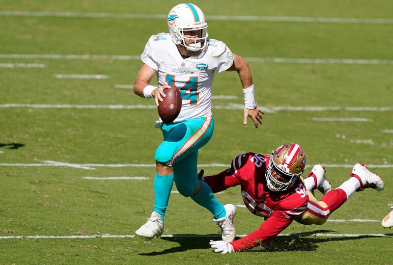 Ryan Fitzpatrick outruns a 49ers defender.