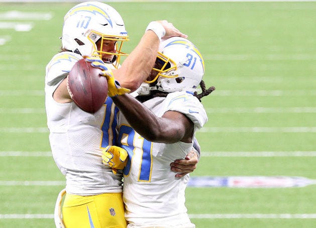 Justin Herbert and Mike Williams (right) celebrate a touchdown against the Saints.