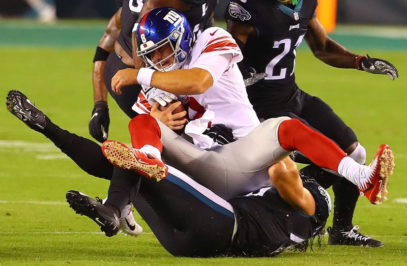 Daniel Jones takes a hit at the hands of the Eagles.