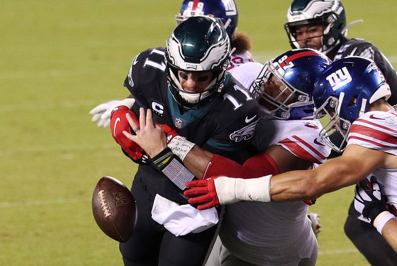Carson Wentz gets wrapped up by a Giants defender.