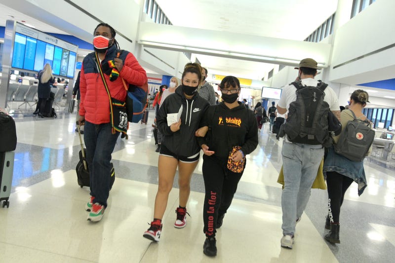 Air travelers walk towards their gates after passing through security at Newark Liberty International Airport on October 22, 2020 in Newark, New Jersey. The global pandemic has had a devastating impact on aviation and airlines don't believe they will see much improvement until a reliable COVID-19 vaccine is developed and distributed.