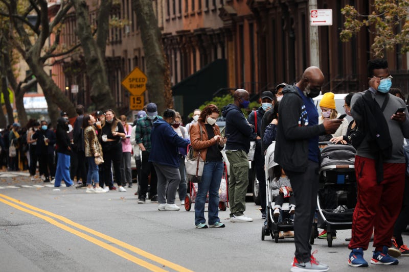 People wait in line outside of a Masonic temple in Brooklyn as early voting begins on October 24, 2020 in New York City.