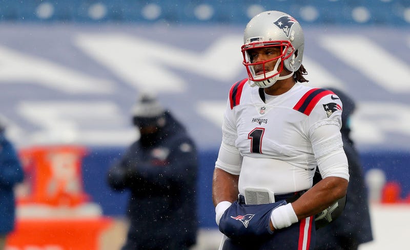 Cam Newton warms his hands before a game.
