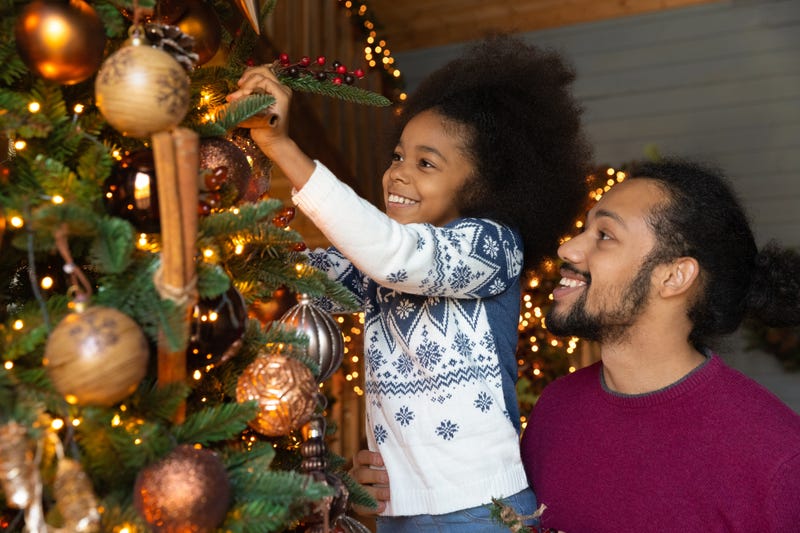 parents having fun while carrying their kids on shoulders on Christmas day at home
