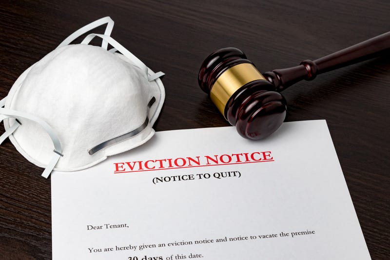 Eviction notice document with gavel and N95 face mask