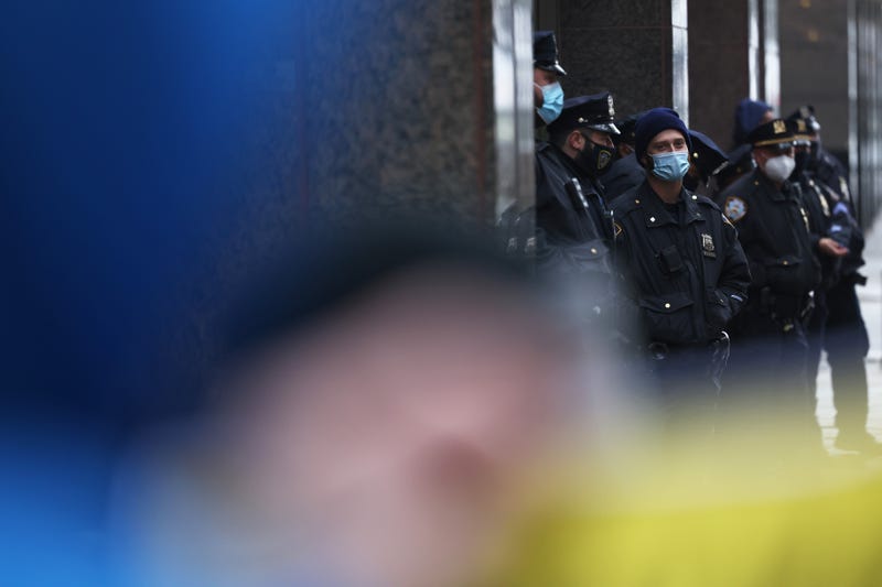 NYPD officers watch as demonstrators hold up signs in front of the NYC office of Jones Day law Firm on November 13, 2020 in New York City.