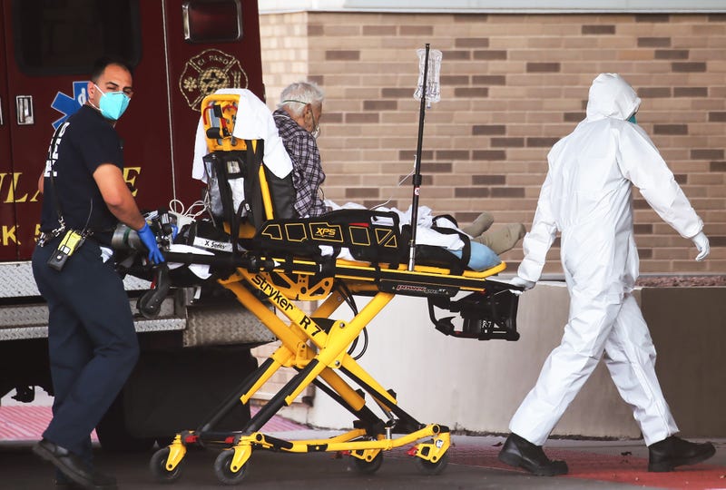 medical worker in full PPE (personal protective equipment) helps transport a patient into University Medical Center amid a surge of COVID-19 cases in El Paso on November 17, 2020 in El Paso, Texas.