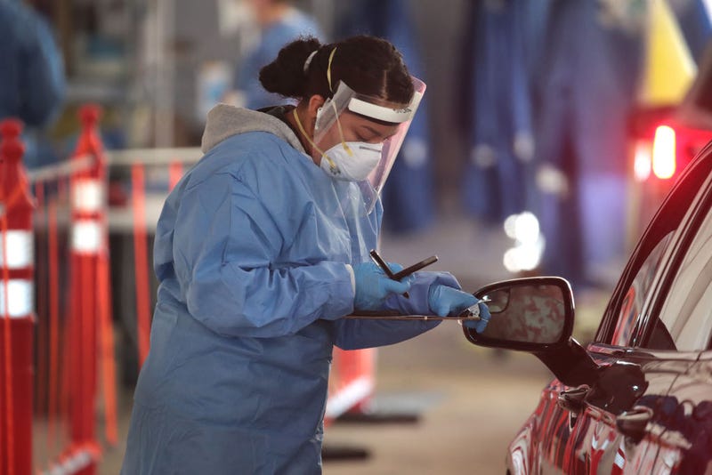 A member of the Wisconsin National Guard helps to test residents for COVID-19 at a drive-up test center at Miller Park on November 17, 2020 in Milwaukee, Wisconsin.