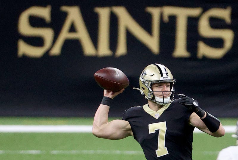 Taysom Hill fires a pass against the Falcons.