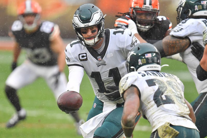 Carson Wentz #11 of the Philadelphia Eagles hands the ball to Miles Sander