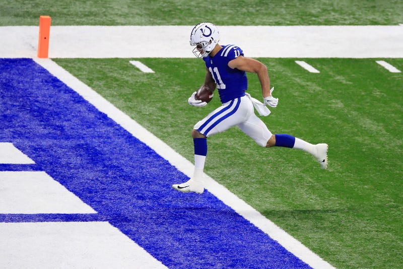 Michael Pittman crosses the goal line for a long touchdown against the Packers.
