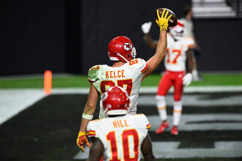 Travis Kelce holds up the football after scoring against the Raiders.