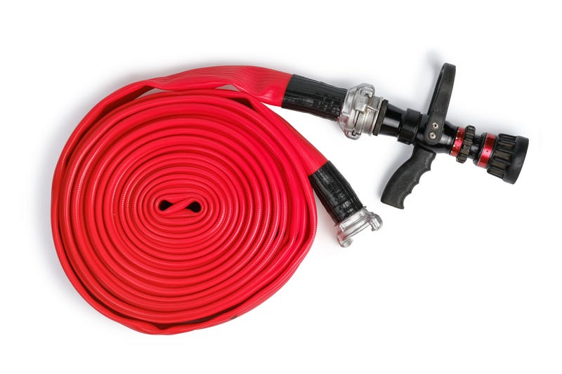 Red rolled firefighter hose isolated on the white background