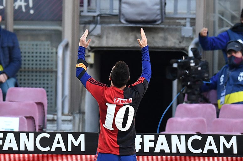 Lionel Messi of Barcelona celebrates after scoring their sides fourth goal while wearing a Newell's Old Boys shirt with the number 10 on the back in memory of former footballer, Diego Maradona, who recently passed away during the La Liga Santander match between FC Barcelona and C.A. Osasuna at Camp Nou on November 29, 2020 in Barcelona, Spain. Sporting stadiums around Spain remain under strict restrictions due to the Coronavirus Pandemic as Government social distancing laws prohibit fans inside venues resulting in games being played behind closed doors.