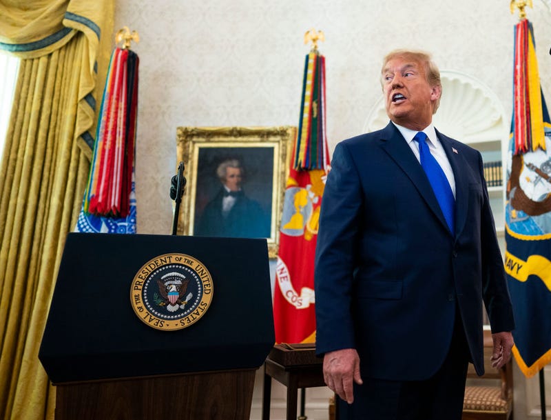 President Donald Trump speaks to the media after presenting the Presidential Medal of Freedom to Dan Gable in the Oval Office on December 07, 2020 in Washington, DC.