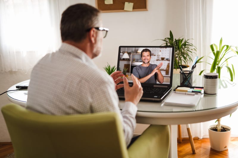 Deaf man talking using sign language on the laptop at home