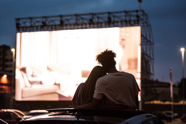 Couple watching movie at Drive-In theater