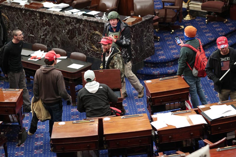 Protesters enter the Senate Chamber on January 06, 2021 in Washington, DC. Congress held a joint session today to ratify President-elect Joe Biden's 306-232 Electoral College win over President Donald Trump.