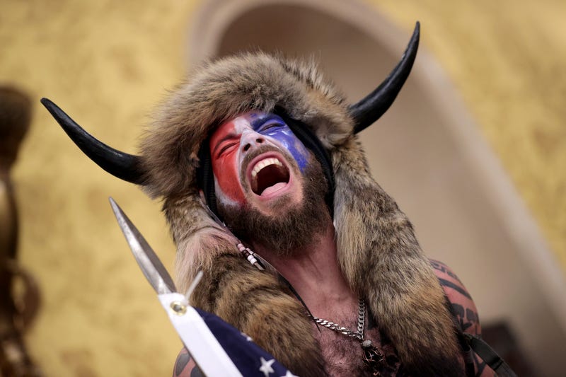 Jacob Chansley screams "Freedom" inside the Senate chamber after the U.S. Capitol was breached by a mob during a joint session of Congress on January 06, 2021 in Washington, DC.