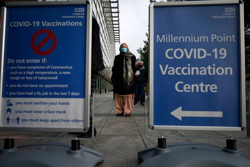 People queue outside the mass NHS Covid-19 vaccine centre that has been set up